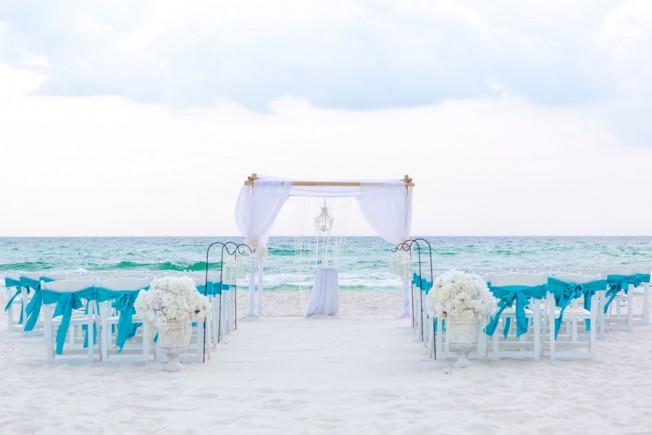 bamboo arbor with turquoise material beach wedding